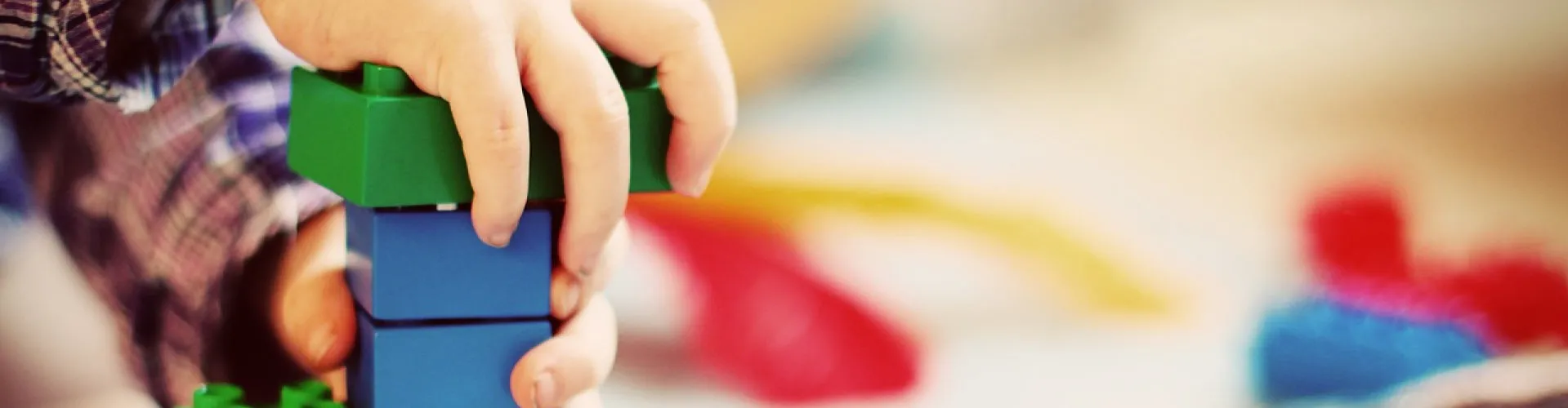 Kinderhand spielt mit Bausteinen